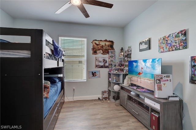 bedroom with light hardwood / wood-style floors and ceiling fan