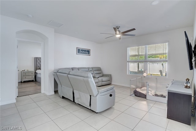 tiled living room with ceiling fan