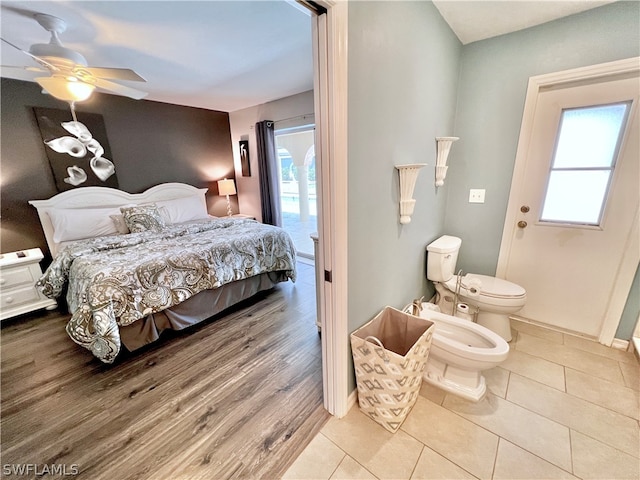 bedroom with ceiling fan and tile floors