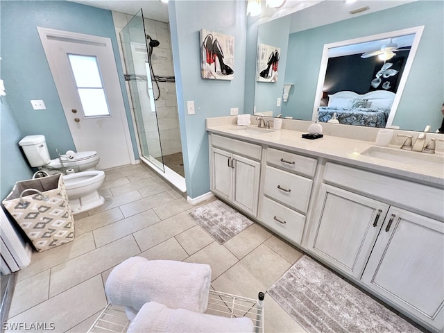 bathroom featuring a shower with shower door, double vanity, toilet, a bidet, and tile floors