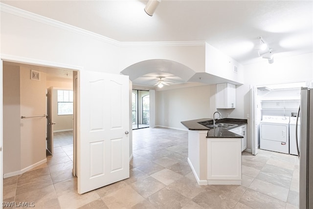 kitchen with washing machine and dryer, white cabinets, light tile flooring, plenty of natural light, and ceiling fan