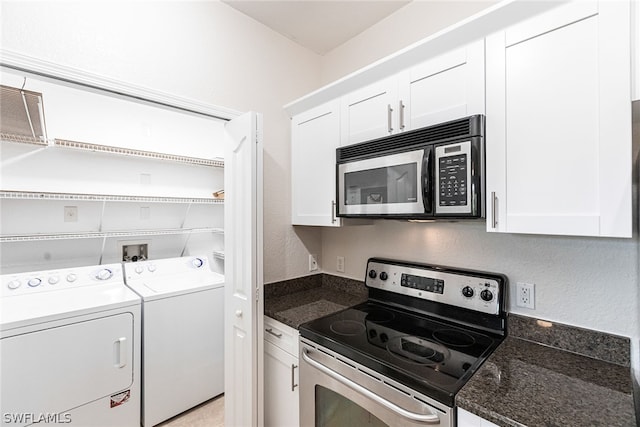 interior space featuring appliances with stainless steel finishes, washer and clothes dryer, and white cabinetry