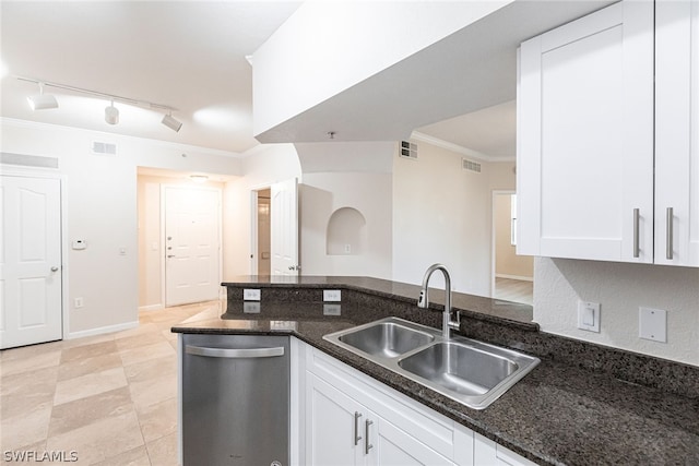 kitchen featuring white cabinets, sink, dark stone countertops, dishwasher, and track lighting