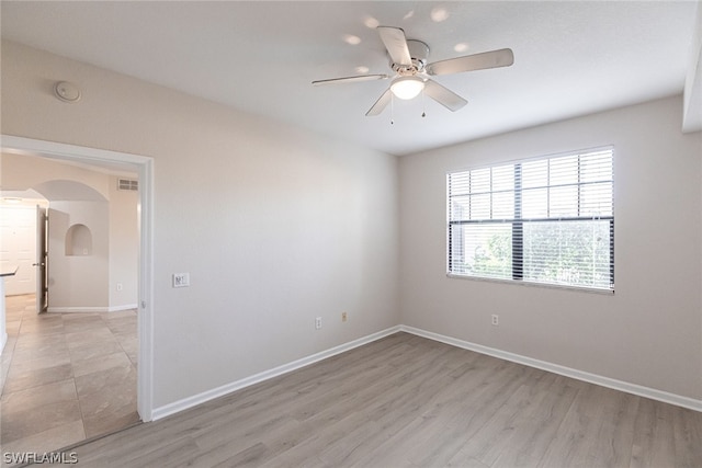 spare room with light hardwood / wood-style flooring and ceiling fan