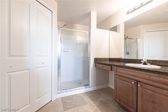 bathroom with tile flooring, vanity, and an enclosed shower