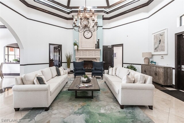 living room with an inviting chandelier, tile flooring, and a high ceiling