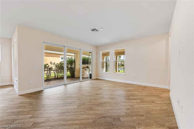 spare room with hardwood / wood-style flooring