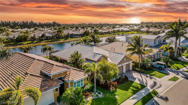 aerial view at dusk with a water view