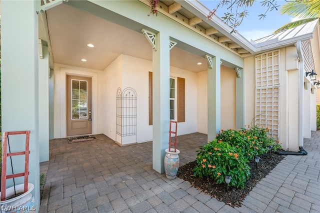 view of exterior entry featuring a patio area