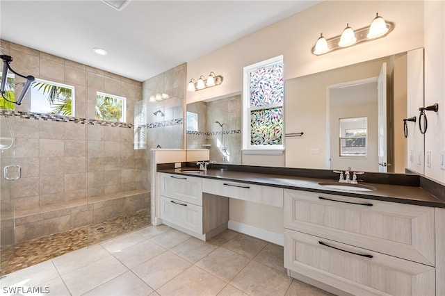 bathroom with an enclosed shower, double vanity, and tile flooring