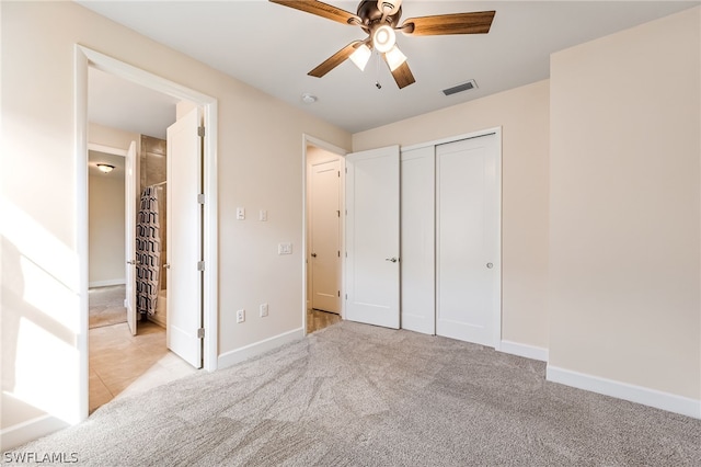 unfurnished bedroom with a closet, ceiling fan, and light carpet