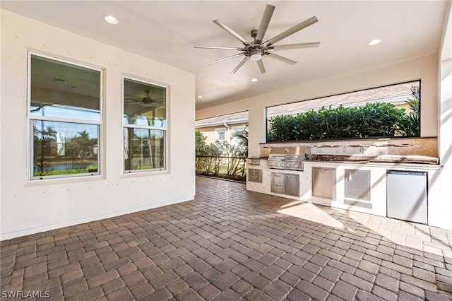 view of patio / terrace with an outdoor kitchen, ceiling fan, and grilling area