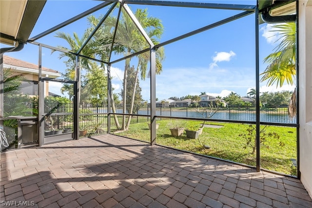 unfurnished sunroom featuring a water view