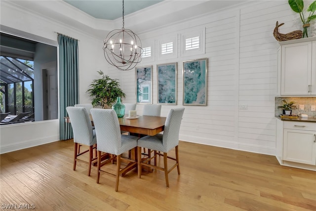 dining area featuring light wood-type flooring and a chandelier