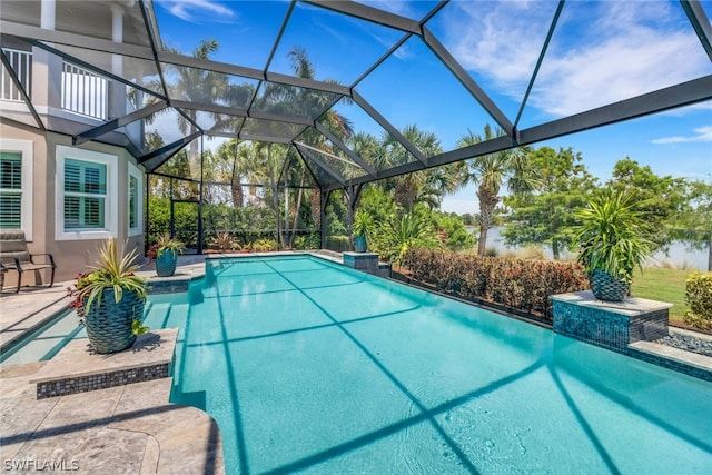 view of swimming pool with glass enclosure and a patio area