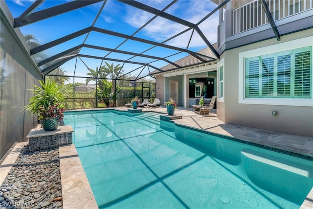 view of swimming pool with a patio and glass enclosure