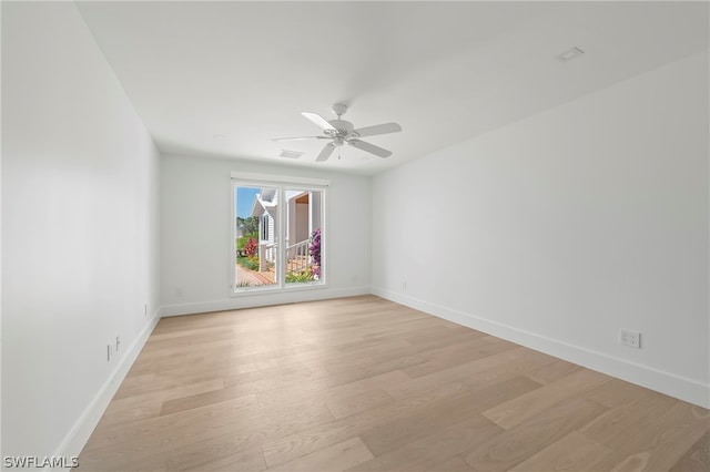 empty room featuring light hardwood / wood-style flooring and ceiling fan