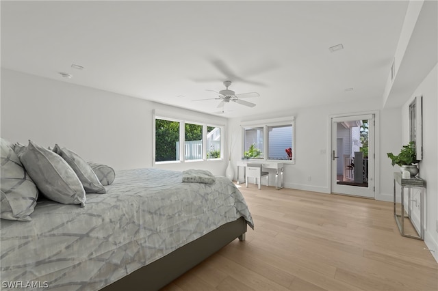 bedroom with light hardwood / wood-style flooring, ceiling fan, and access to exterior