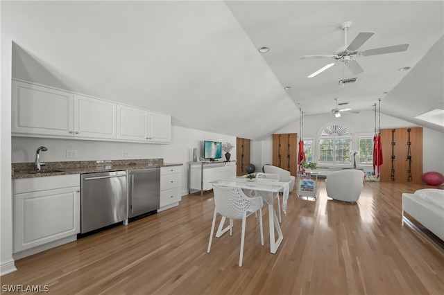 kitchen with dishwasher, white cabinetry, lofted ceiling, light hardwood / wood-style flooring, and stone counters