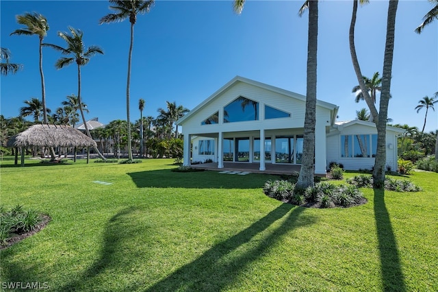 back of house with a gazebo and a yard