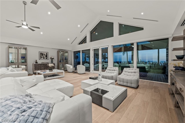 living room with high vaulted ceiling, light hardwood / wood-style floors, and ceiling fan