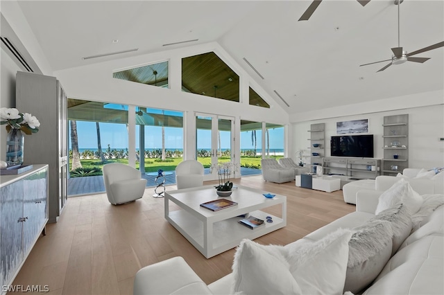 living room with built in shelves, ceiling fan, high vaulted ceiling, and hardwood / wood-style floors