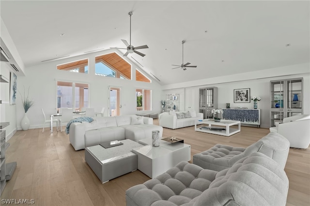 living room featuring light hardwood / wood-style flooring, high vaulted ceiling, ceiling fan, and french doors