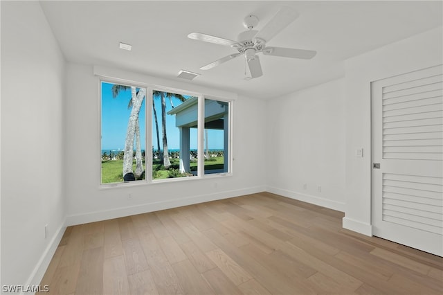 spare room with light hardwood / wood-style floors and ceiling fan