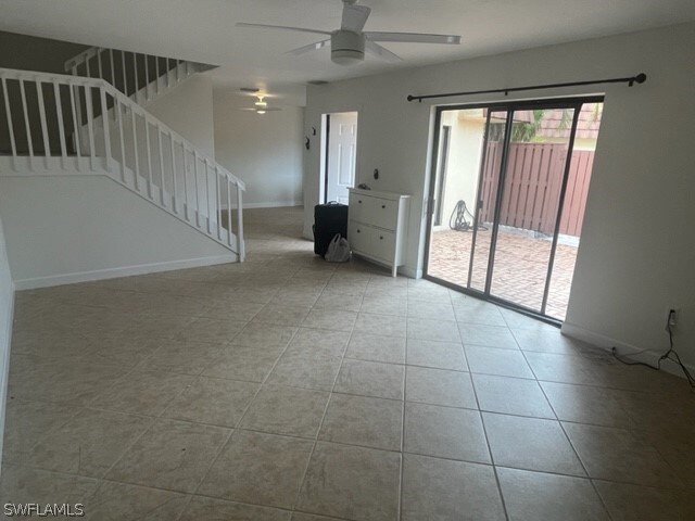 tiled spare room with ceiling fan