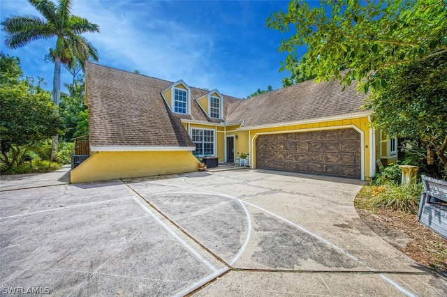 cape cod-style house with a garage