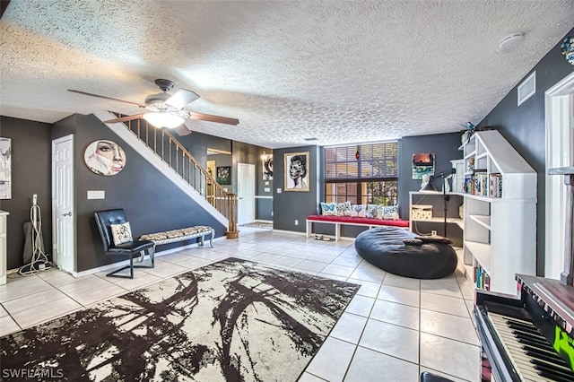 tiled living room featuring ceiling fan and a textured ceiling