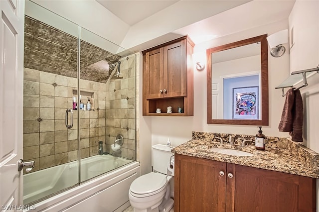 full bathroom with vanity, enclosed tub / shower combo, and toilet