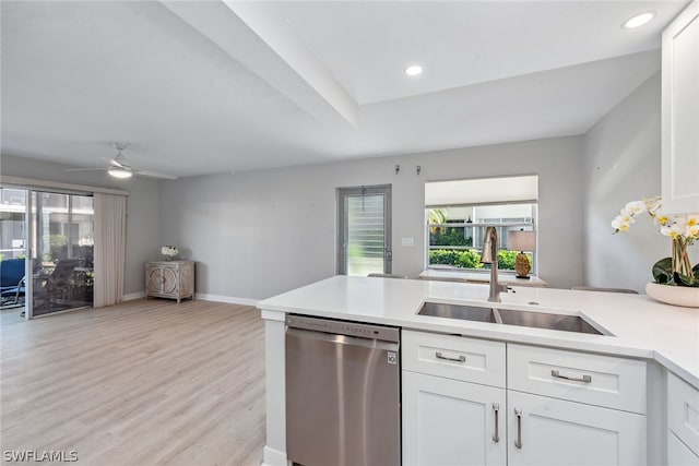 kitchen with light wood-type flooring, white cabinetry, sink, dishwasher, and ceiling fan