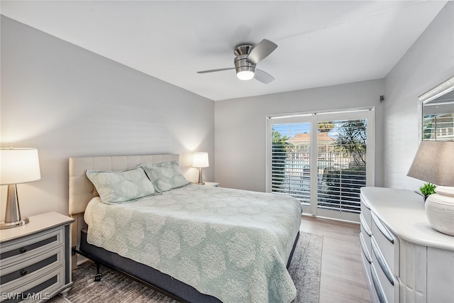 bedroom featuring access to outside, light hardwood / wood-style flooring, and ceiling fan