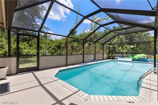 view of swimming pool with a lanai and a patio