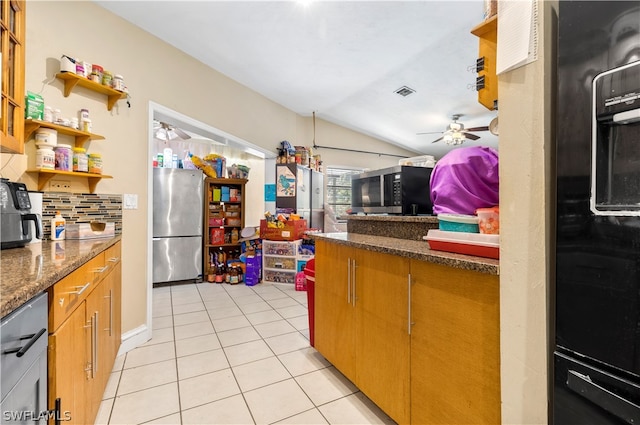 kitchen with backsplash, stainless steel appliances, dark stone countertops, ceiling fan, and lofted ceiling