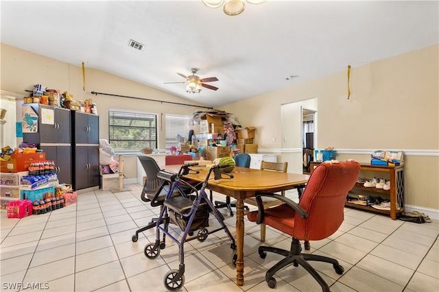 tiled dining area with ceiling fan and vaulted ceiling