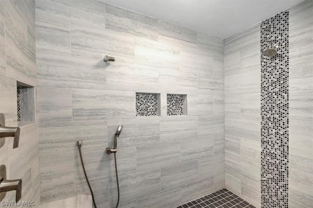 bathroom with tiled shower