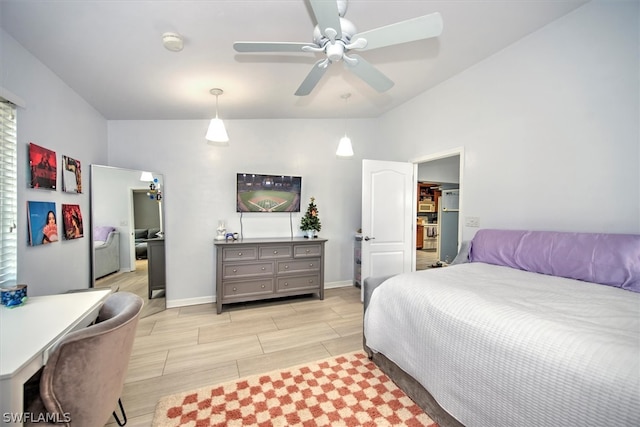 bedroom with a spacious closet and ceiling fan