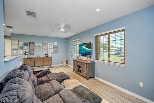 living room featuring ceiling fan and light wood-type flooring