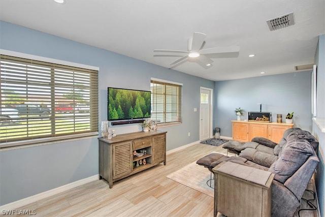 living room featuring ceiling fan, a healthy amount of sunlight, and light hardwood / wood-style floors