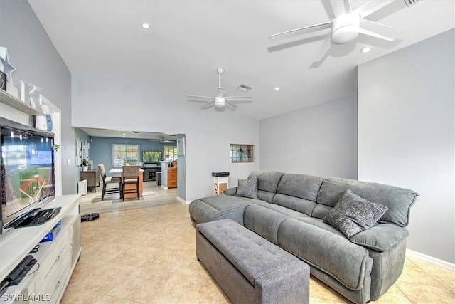 living room with vaulted ceiling, light tile patterned floors, and ceiling fan