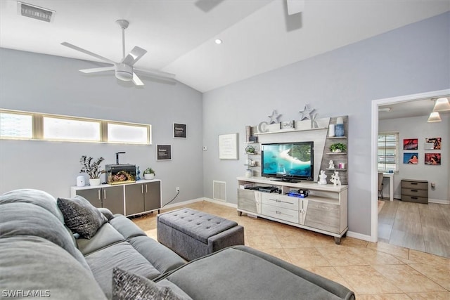 living room featuring vaulted ceiling, ceiling fan, and light tile patterned flooring