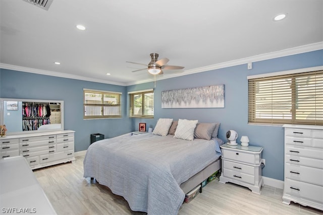 bedroom featuring ceiling fan, ornamental molding, and light hardwood / wood-style floors