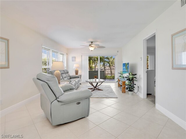 living room featuring ceiling fan and light tile patterned flooring