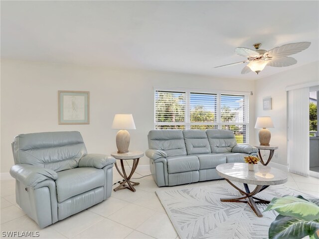 living room featuring a wealth of natural light, ceiling fan, and light tile patterned floors