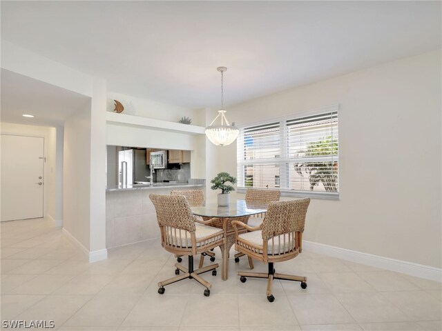 dining room with a notable chandelier and light tile patterned floors