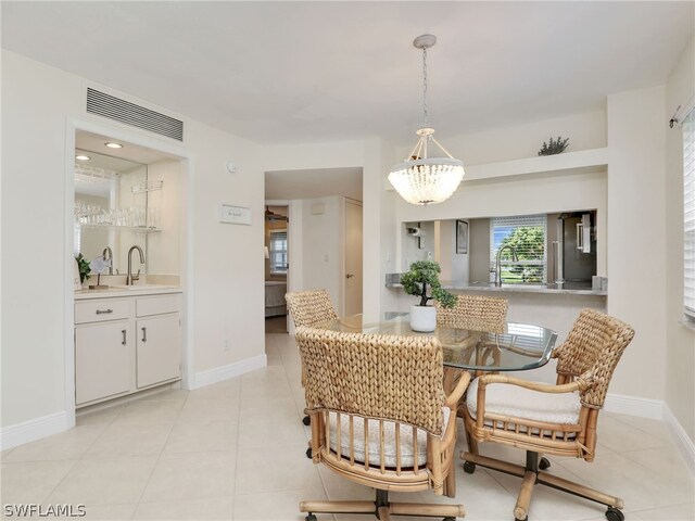 dining room with light tile patterned floors and sink