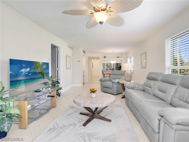 living room with ceiling fan and light tile patterned floors