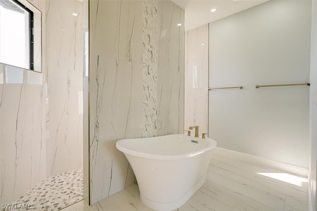 bathroom featuring tile floors and a tile shower